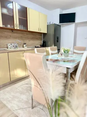 a kitchen and dining room with a table and chairs at The Central Suite in Petrich