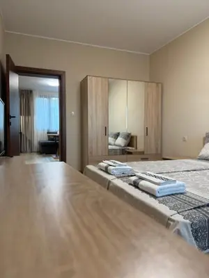 a bedroom with a large bed with two towels on it at Asen Tsvetkov Apartment in Sandanski