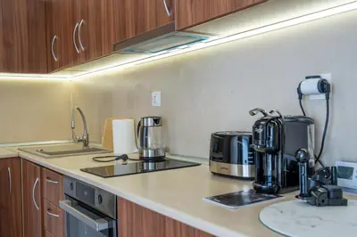 a kitchen counter with a coffee maker on it at Evgeny's Stylishly Designed 2 Bedroom Apartment plus Garage! in Sofia