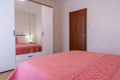 a bedroom with a pink bed and a mirror at Evgeny's Stylishly Designed 2 Bedroom Apartment plus Garage! in Sofia