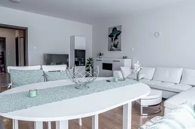 a living room with a white table and a white couch at Evgeny's Stylishly Designed 2 Bedroom Apartment plus Garage! in Sofia