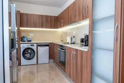 a kitchen with a washing machine and a washer at Evgeny's Stylishly Designed 2 Bedroom Apartment plus Garage! in Sofia