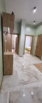 a large room with a marble floor and a bathroom at Green apartment Velingrad in Velingrad