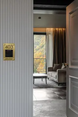 a living room with a couch and a window at Villa Rossa Luxury & Spa Residence in Narechenski Bani