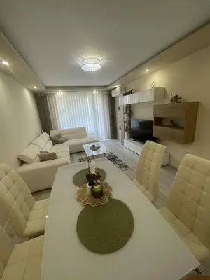 a living room with a couch and a table and chairs at 2 Bedroom apartment in Gotse Delchev
