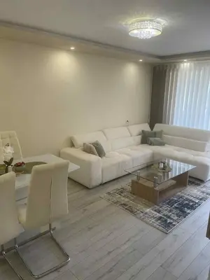 a living room with a white couch and a coffee table at 2 Bedroom apartment in Gotse Delchev