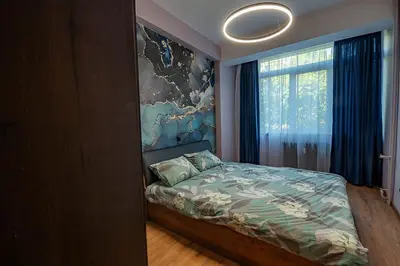a bedroom with a bed and a large window at 1 minute to main Street & NDK & Free Parking in Sofia