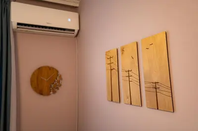a wall with three paintings of utility poles and a clock at 1 minute to main Street & NDK & Free Parking in Sofia
