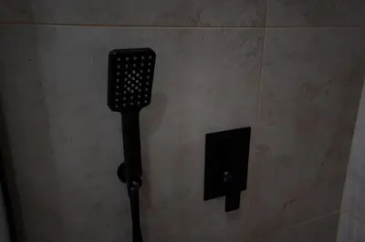 a black object on a wall in a bathroom at 1 minute to main Street & NDK & Free Parking in Sofia