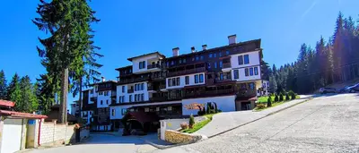 a large building on the side of a street at Tulip Studio Deluxe, Grand Resort Pamporovo in Pamporovo