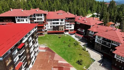 an overhead view of a group of buildings with red roofs at Tulip Studio Superior, Grand Resort Pamporovo in Pamporovo