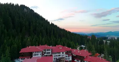 a group of buildings on the side of a mountain at Tulip Studio Superior, Grand Resort Pamporovo in Pamporovo