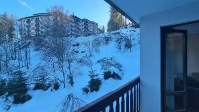 a view of a snow covered hill from a balcony at Cedar Heights 1 Виванко А7 in Pamporovo