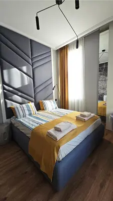 a bedroom with a large bed with towels on it at FS Apartments Romantic Kapana View Room in Plovdiv