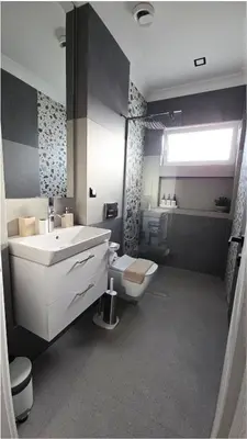 a bathroom with a white sink and a toilet at FS Apartments Romantic Kapana View Room in Plovdiv