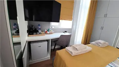 a room with a desk and a table with towels at FS Apartments Romantic Kapana View Room in Plovdiv