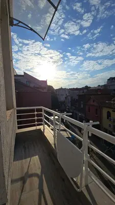 a balcony with a chair on top of a building at FS Apartments Romantic Kapana View Room in Plovdiv