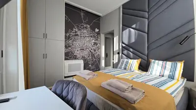 a bedroom with a bed with towels on it at FS Apartments Romantic Kapana View Room in Plovdiv