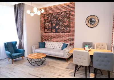 a living room with a couch and a table and chairs at FS Apartments Kapana Boutique Family Stay in Plovdiv