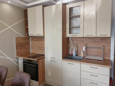 a kitchen with white cabinets and a sink at Strumsko Stay in Blagoevgrad
