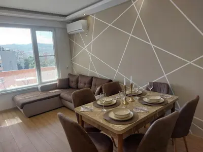 a living room with a table and a couch at Strumsko Stay in Blagoevgrad