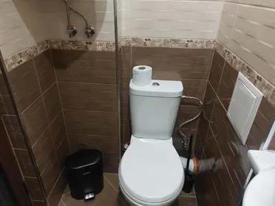a bathroom with a toilet with a roll of toilet paper on it at Strumsko Stay in Blagoevgrad