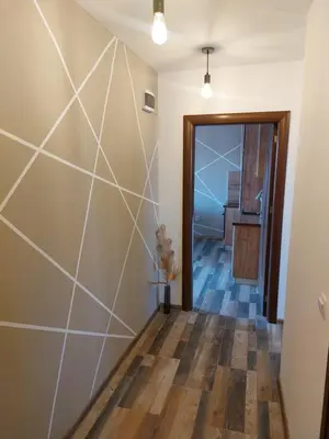 a hallway with a large wall with a wooden floor at Strumsko Stay in Blagoevgrad