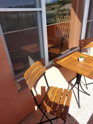 a table and two chairs on a porch with a table at Strumsko Stay in Blagoevgrad