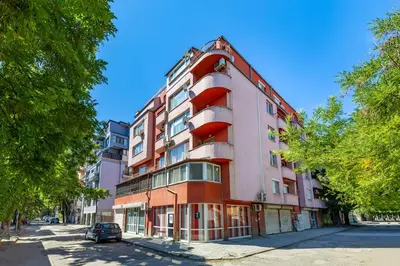 a tall red building on the side of a street at Comfort Corner - 1BD with Balcony by Flat Mаnager in Plovdiv