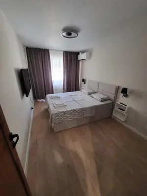 a bedroom with a bed and a television in it at cosy apartment in Sofia