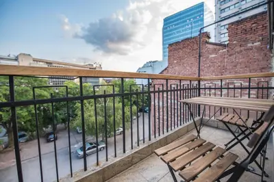 a balcony with a wooden bench and a table at Alexandra's City Center Apartment I in Sofia