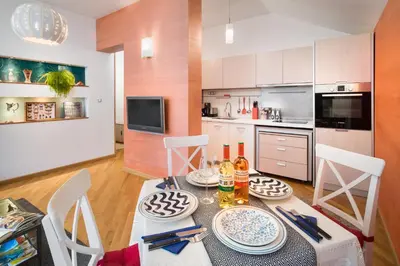 a kitchen and dining room with a table and chairs at Alexandra's City Center Apartment I in Sofia