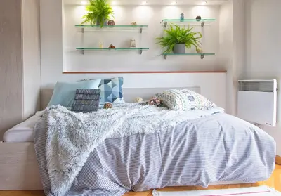 a bedroom with a bed with plants on the wall at Alexandra's City Center Apartment I in Sofia