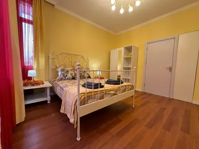 a bedroom with a bed and a wooden floor at Central Family Residence in Sofia