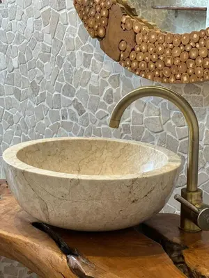 a stone sink on a table in a bathroom at Central Family Residence in Sofia