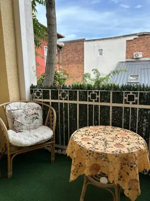 a patio with a table and a chair and a table and a table and chairs at Central Family Residence in Sofia