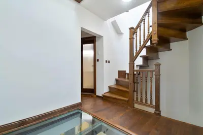 a hallway with a glass floor and wooden stairs at Blue House in Plovdiv