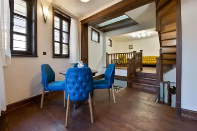 a dining room with blue chairs and a table at Blue House in Plovdiv