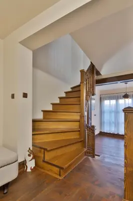 a staircase in a house with wooden floors and white walls at Blue House in Plovdiv