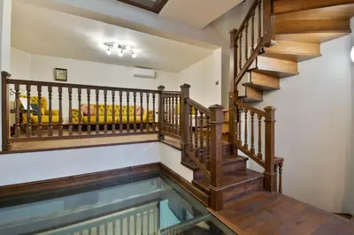 an indoor swimming pool with a wooden staircase and a house at Blue House in Plovdiv