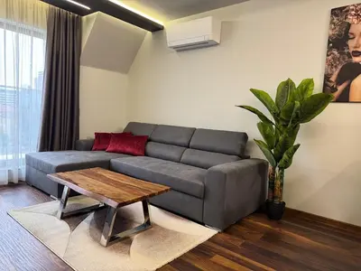 a living room with a couch and a coffee table at Dream Home A21 in Sofia