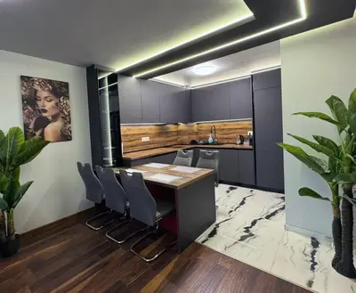 a kitchen with a wooden table and chairs at Dream Home A21 in Sofia