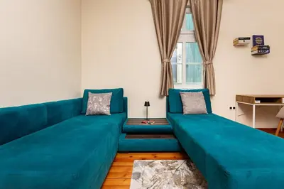 a living room with a large blue couch at Apt Kosmos in the best Central Area in Plovdiv in Plovdiv