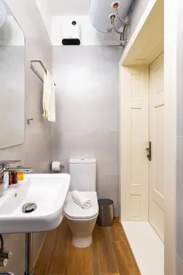 a bathroom with a white toilet and a sink at Apt Kosmos in the best Central Area in Plovdiv in Plovdiv