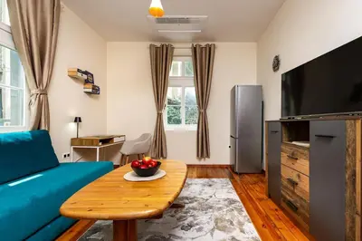 a living room with a blue couch and a table at Apt Kosmos in the best Central Area in Plovdiv in Plovdiv