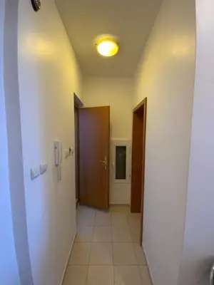 a hallway with two doors and a tile floor at Zaimov Penthouse with great view in Sofia