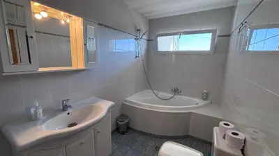 a white bathroom with a sink and a toilet at Zaimov Penthouse with great view in Sofia