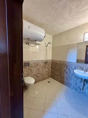 a bathroom with a toilet and a sink at Comfy Apt next to Palace of Justice in Sofia