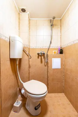 a bathroom with a toilet and a shower at Sunflower Studio next to Kolodrum Plovdiv in Plovdiv