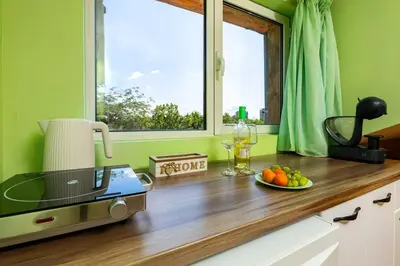 a kitchen with a counter with a plate of fruit and a window at Sunflower Studio next to Kolodrum Plovdiv in Plovdiv